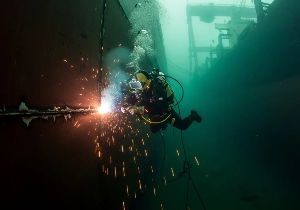 a Professional welder is doing underwater welding 
